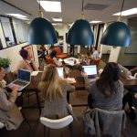 group of people meeting in large office