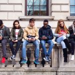 Teenagers students using smartphone on a school break