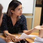 Asian team leader holding business meeting with colleagues