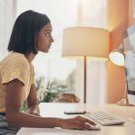 Indian woman on desktop computer at home