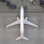 Top down view of a white airplane on the tarmac