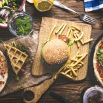 Top view of an assortment of food on wood table