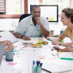 Business professionals around conference table discussing the benefits of content marketing