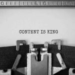 Close up of a typerwriter with the words 'content is king' for content marketing kpis